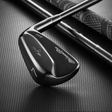 Mizuno Pro 225 Black ION lying on black background on top of golf shaft and golf grip