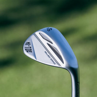 TaylorMade Hi-Toe 3 Wedge being held up on a grass background. The back of the club head is visible and shows the four chambers on the back of the head.