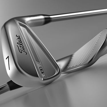 Two Titleist 2023 T100 Golf Irons lying on top of each other on a grey background.
