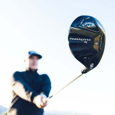 Callaway Paradym X Golf Hybrid being held by golfer with it stretched out